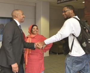 President Jeffrey Boyd shaking hands with male student